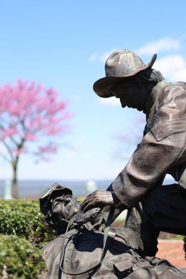 A sculpture of a Confederate soldier giving water to a Union soldier, in “Moment of Mercy” by Terry Jones. (Courtesy The National Civil War Museum)