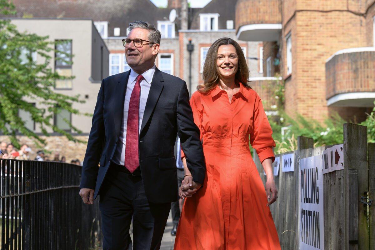 Leader of the Labour Party Sir Keir Starmer walks with his wife Victoria Starmer, as they arrive at a polling station to place their votes in the general election, in London on July 4, 2024. (Leon Neal/Getty Images)