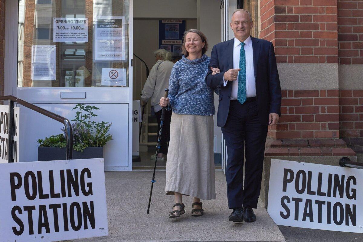 Leader of the Liberal Democrats, Sir Ed Davey, and his wife, Emily Gasson, leave the polling station after voting in the UK general election, in Surbiton, England, on July 4, 2024. (Alex McBride/Getty Images)
