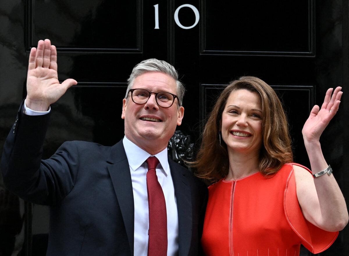 Britain's incoming Prime Minister Keir Starmer and his wife Victoria wave as they pose on the steps of 10 Downing Street in London on July 5, 2024. (Justin Tallis/AFP via Getty Images)