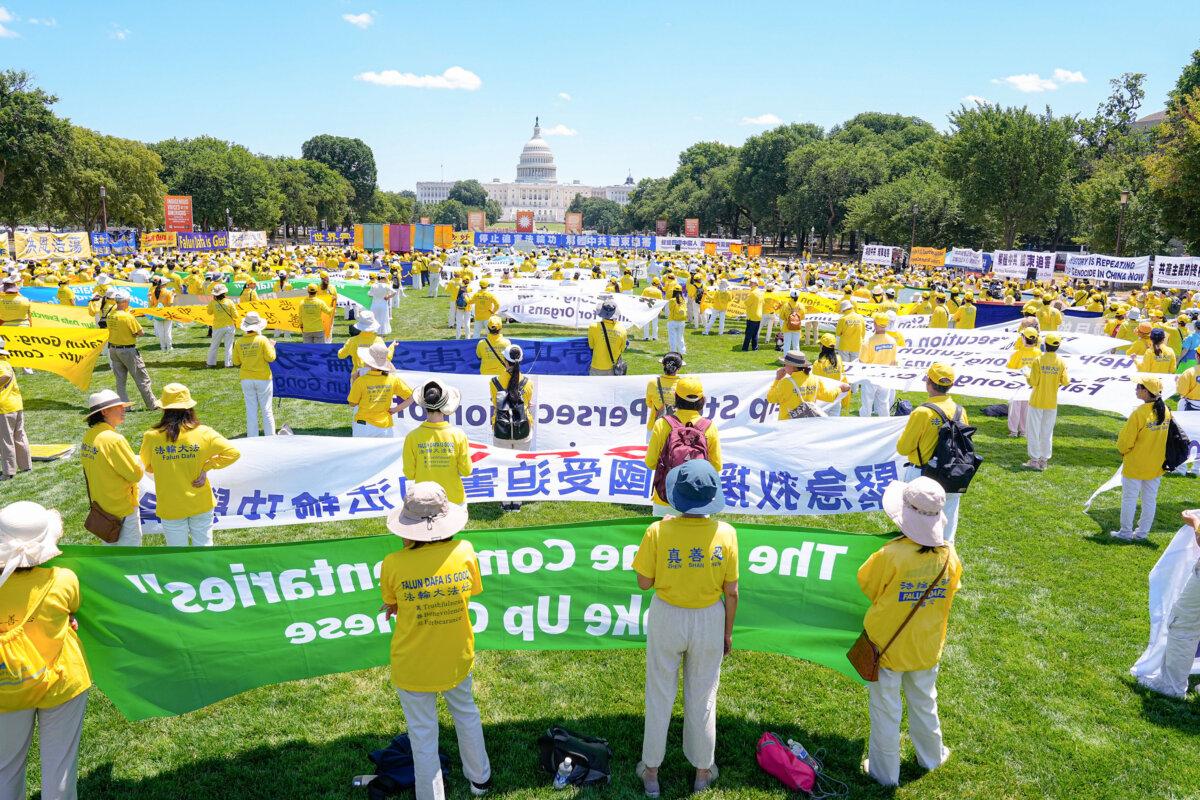 Falun Gong practitioners call for an end to the Chinese Communist Party’s 25-year-long persecution of the spiritual practice at a rally at the National Mall in Washington on July 11, 2024. (Larry Dye/The Epoch Times)