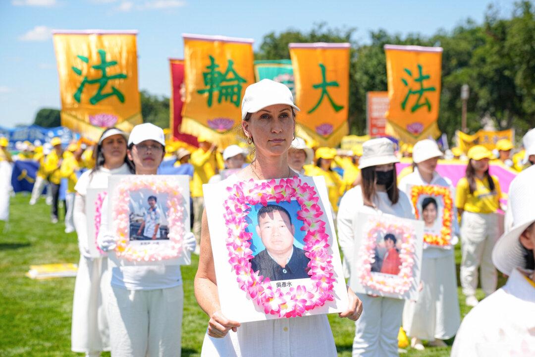 Falun Gong adherents take part in a rally calling for the end of the Chinese Communist Party’s 25 years of ongoing persecution of Falun Gong practitioners in China at the National Mall in Washington on July 11, 2024. (Larry Dye/The Epoch Times)