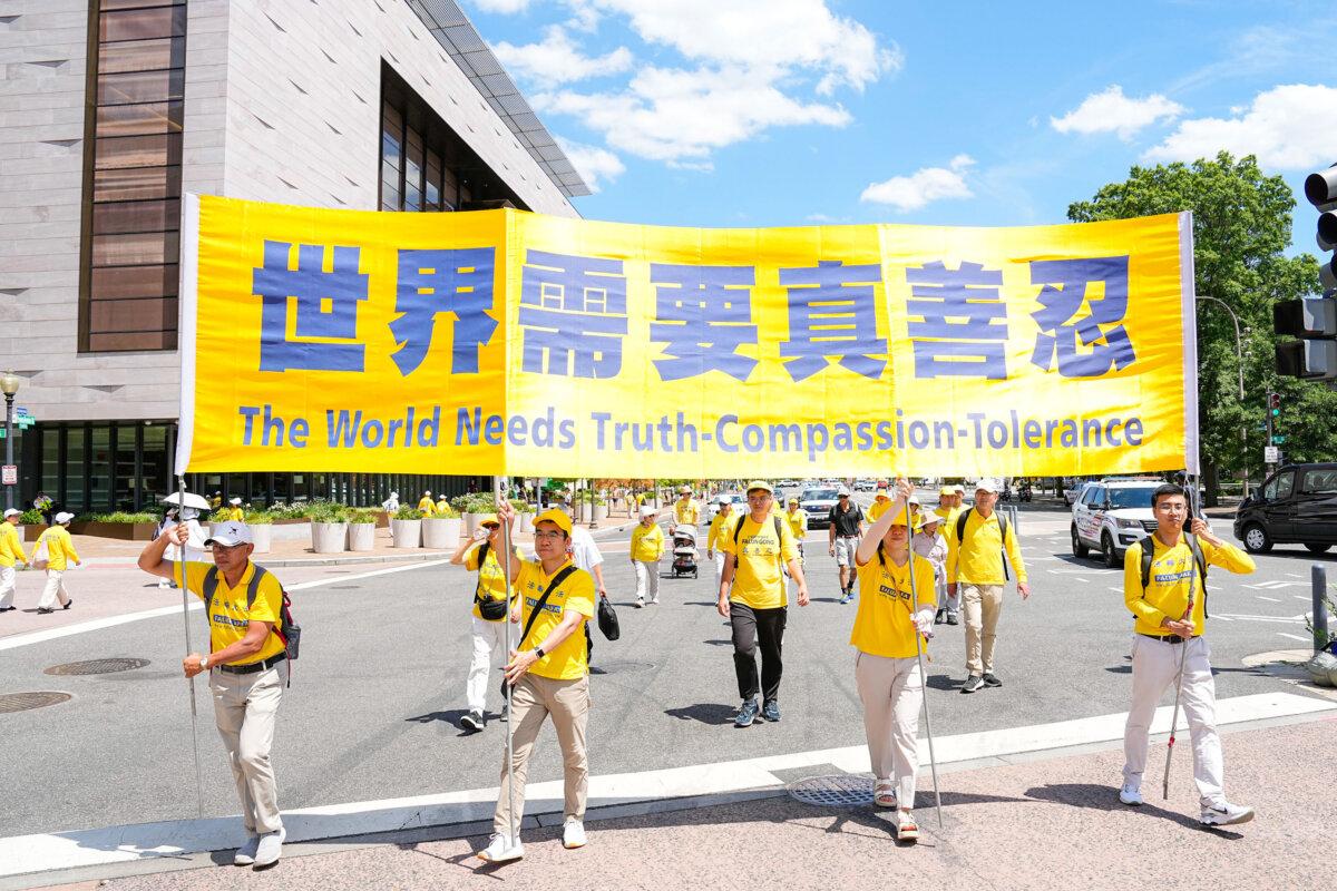 Falun Gong adherents march during a parade calling for the end of the Chinese Communist Party’s 25 years of ongoing persecution of Falun Gong practitioners in China at the National Mall in Washington on July 11, 2024. (Larry Dye/The Epoch Times)