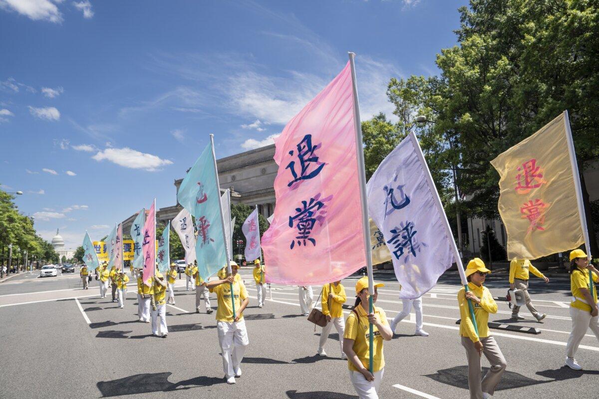 Falun Gong practitioners march during a parade calling for an end to the Chinese Communist Partys 25-year-long persecution of the spiritual practice at the National Mall in Washington on July 11, 2024.(Madalina Vasiliu/The Epoch Times)