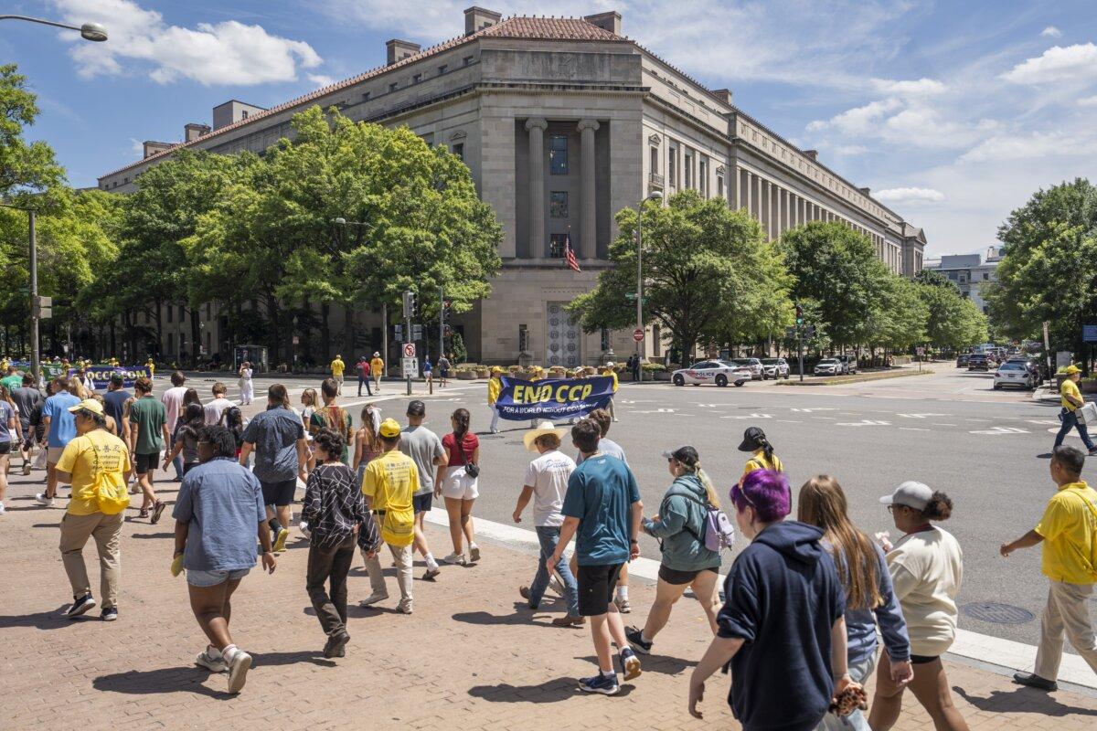 Falun Gong practitioners march during a parade calling for an end to the Chinese Communist Partys 25-year-long persecution of the spiritual practice at the National Mall in Washington on July 11, 2024.(Madalina Vasiliu/The Epoch Times)