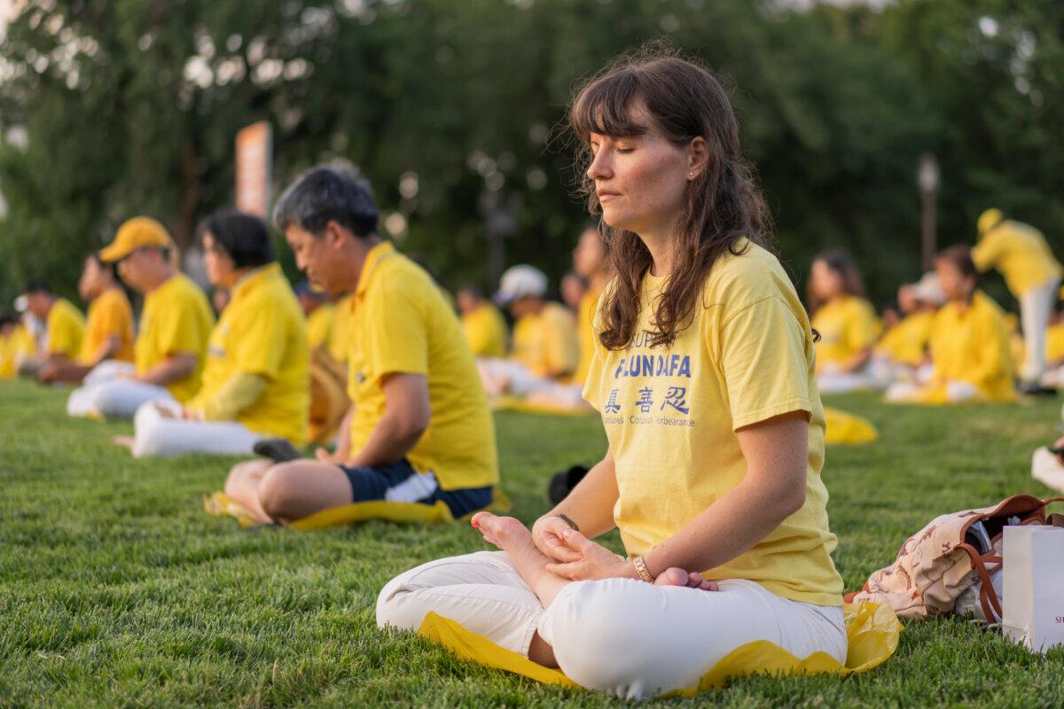 Falun Gong practitioners gather for a candlelight vigil commemorating Falun Gong practitioners’ persecution to death in China by the Chinese Communist Party at the National Mall in Washington on July 11, 2024. (Madalina Vasiliu/The Epoch Times)