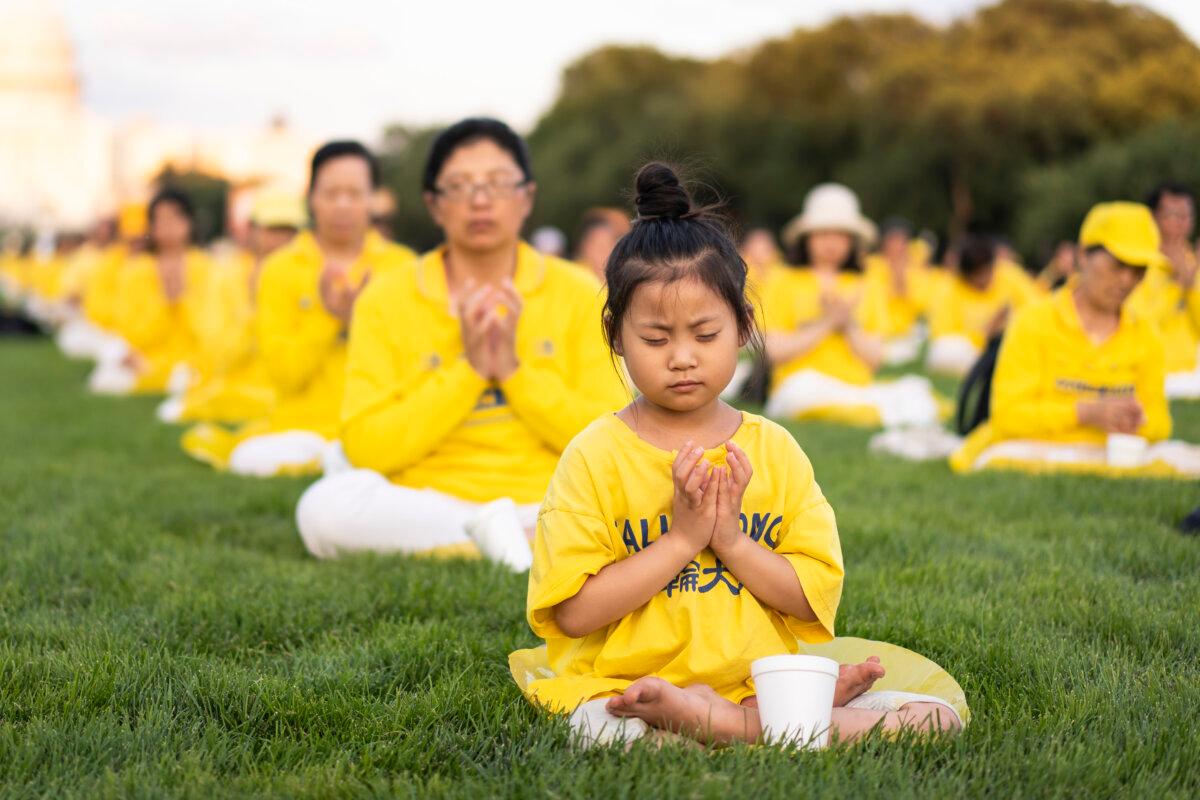 Falun Gong practitioners gather for a candlelight vigil commemorating Falun Gong practitioners’ persecution to death in China by the Chinese Communist Party at the National Mall in Washington on July 11, 2024. (Madalina Vasiliu/The Epoch Times)