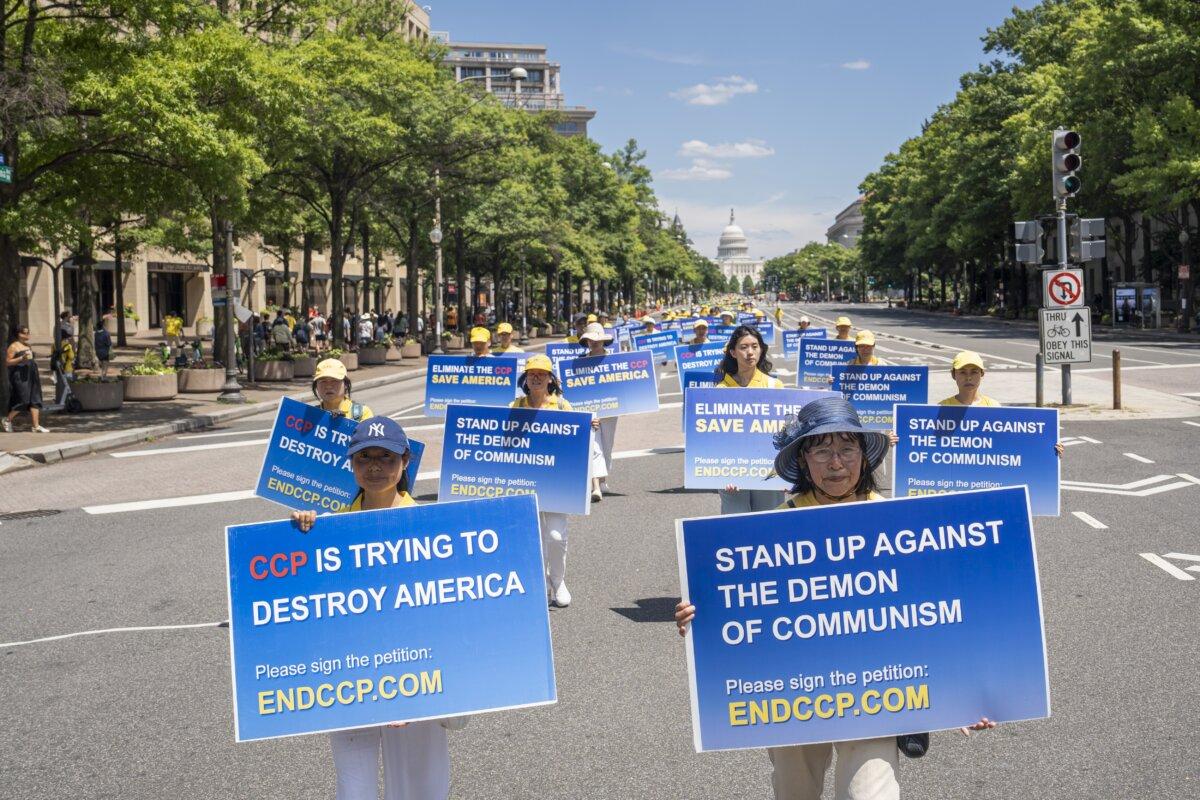 Falun Gong practitioners march during a parade calling for an end to the Chinese Communist Partys 25-year-long persecution of the spiritual practice at the National Mall in Washington on July 11, 2024.(Madalina Vasiliu/The Epoch Times)