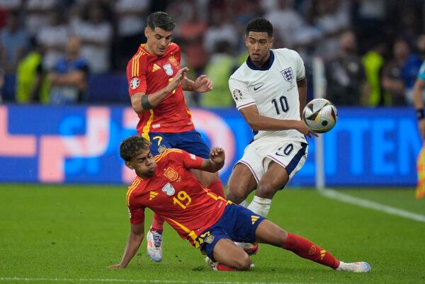 From left, Spain's Lamine Yamal, Spain's Alvaro Morata, and England's Jude Bellingham fight for the ball during the final match between Spain and England at the Euro 2024 soccer tournament in Berlin, on July 14, 2024. (Matthias Schrader/AP Photo)