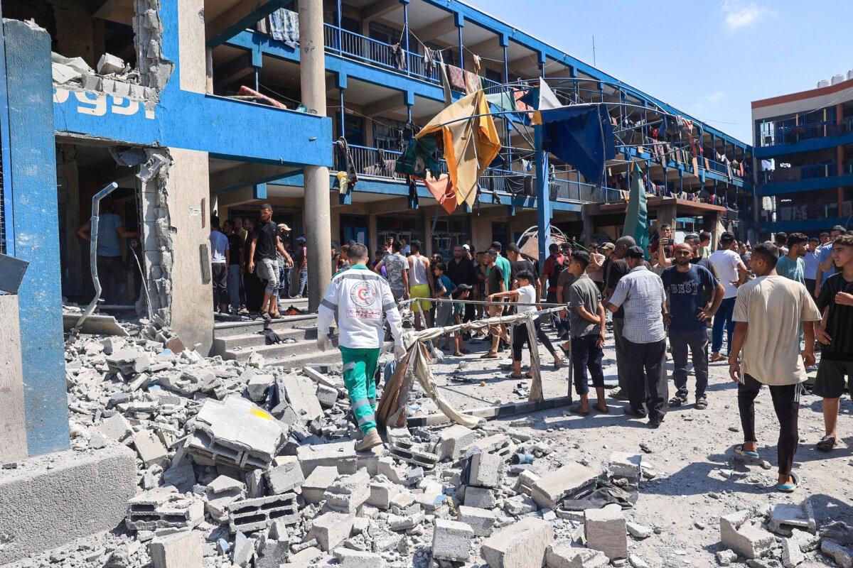 Palestinians survey the damage following an Israeli military bombardment of a UNRWA (United Nations Relief and Works Agency for Palestine Refugees) facility in the Nuseirat refugee camp, in the central Gaza Strip on July 14, 2024. (Eyad Baba/AFP via Getty Images)