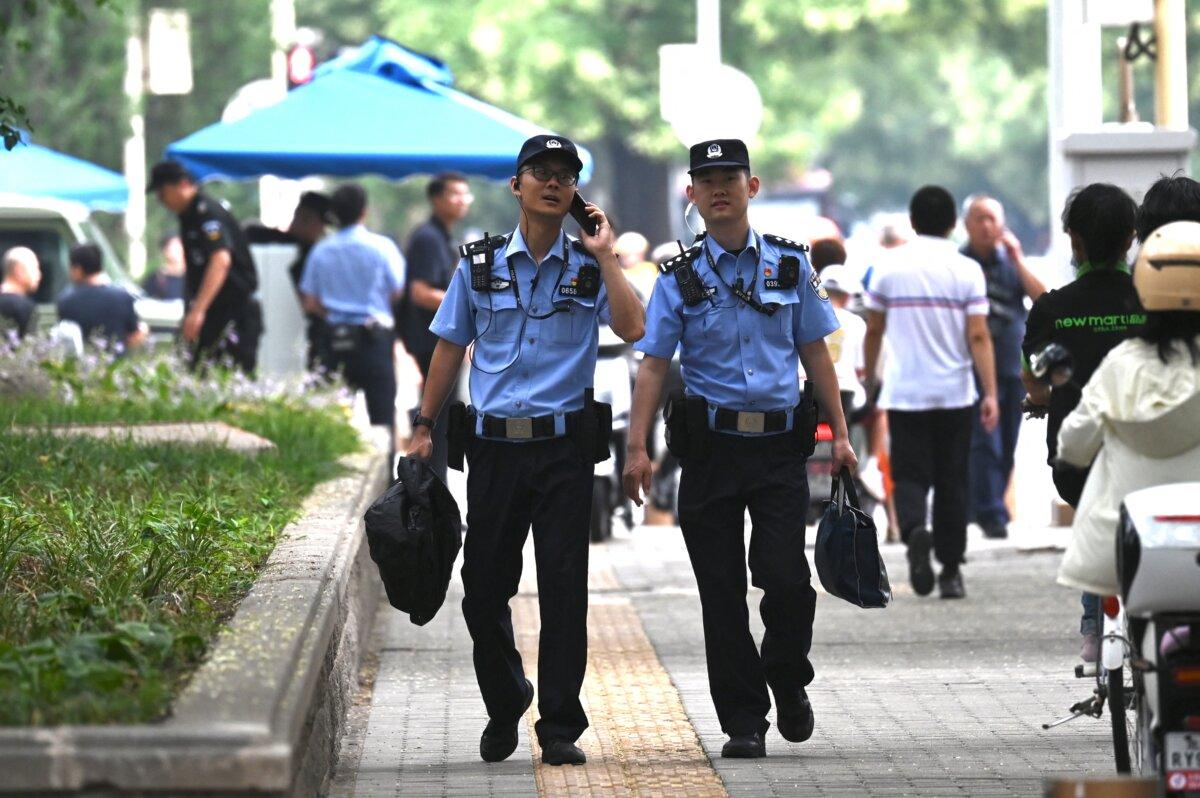 Police officers patrol outside the Jingxi Hotel in Beijing on July 15, 2024. (Greg Baker/AFP via Getty Images)