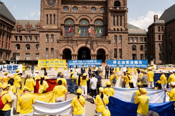 Falun Gong practitioners and supporters attend a rally at Queen's Park in Toronto on July 20, 2024, commemorating the 25th anniversary of the Chinese regime's persecution of Falun Gong. (Evan Ning/The Epoch Times)