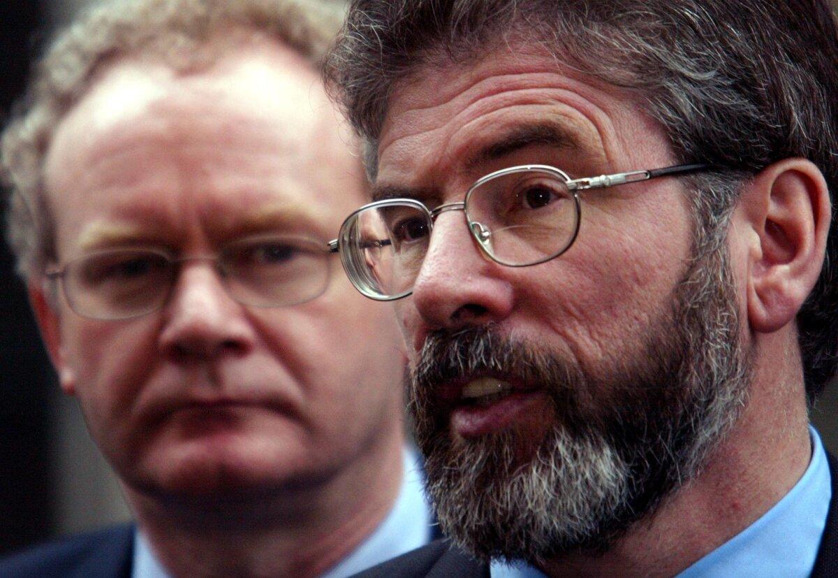 Sinn Fein leader and deputy Gerry Adams (R) and fellow deputy Martin McGuinness address the press outside Number 10 Downing Street ahead of a meeting with British Prime Minister Tony Blair in London on Jan. 21, 2002. (Odd Andersen/AFP via Getty Images)