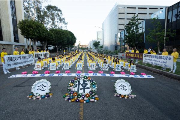 Falun Gong practitioners hold a candlelight vigil in front of the Chinese Consulate to mark 25 years of persecution by the Chinese Communist Party, in Los Angeles on July 20, 2024. (Alex Lee/The Epoch Times)