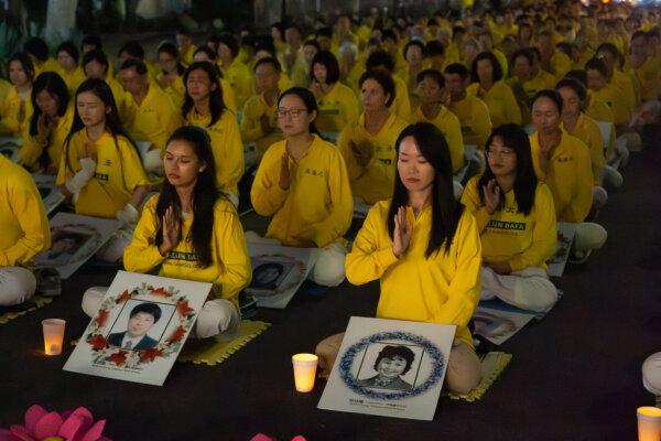 Falun Gong practitioners hold a candlelight vigil in front of the Chinese Consulate to mark 25 years of the Chinese Communist Party's persecution of Falun Gong in China, in Los Angeles on July 20, 2024. (Alex Lee/The Epoch Times)