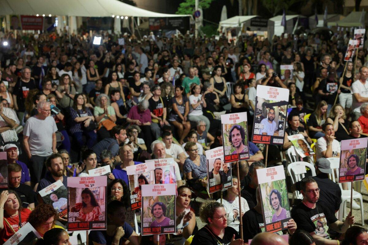 Israelis and hostage families watch a screening of Israeli Prime Minister Benjamin Netanyahu as he addresses Congress on a visit to the United States amid the ongoing conflict in Gaza between Israel and Hamas, at the so-called "Hostages Square," in Tel Aviv, Israel, on July 24, 2024. (Ricardo Moraes/Reuters)