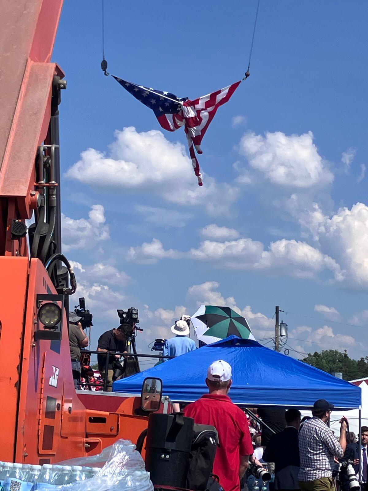 An American flag is twisted in the shape of what some people viewed as an angel, about two hours before an assassination attempt on former President Donald Trump in Butler, Pa., on July 13, 2024. (Janice Hisle/The Epoch Times)