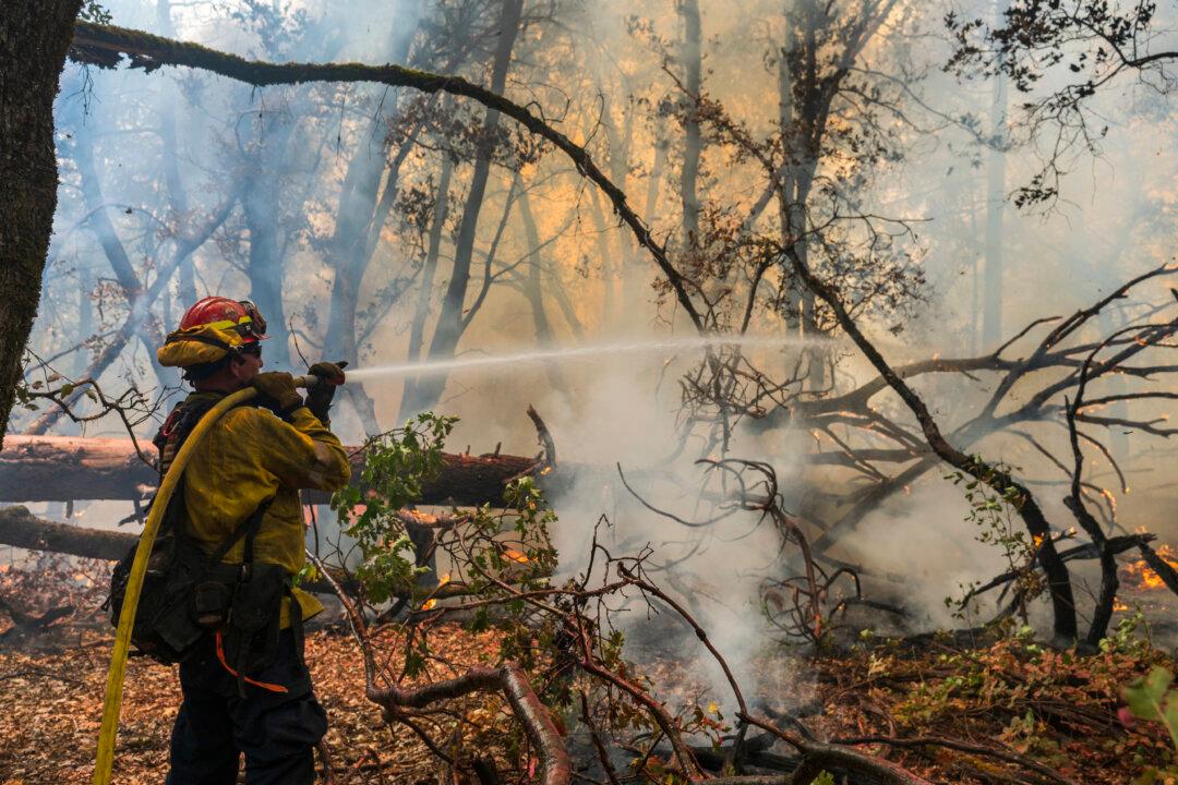 Firefighters Helped by Cooler Weather Battle Blaze That Has Scorched Area Larger Than Los Angeles