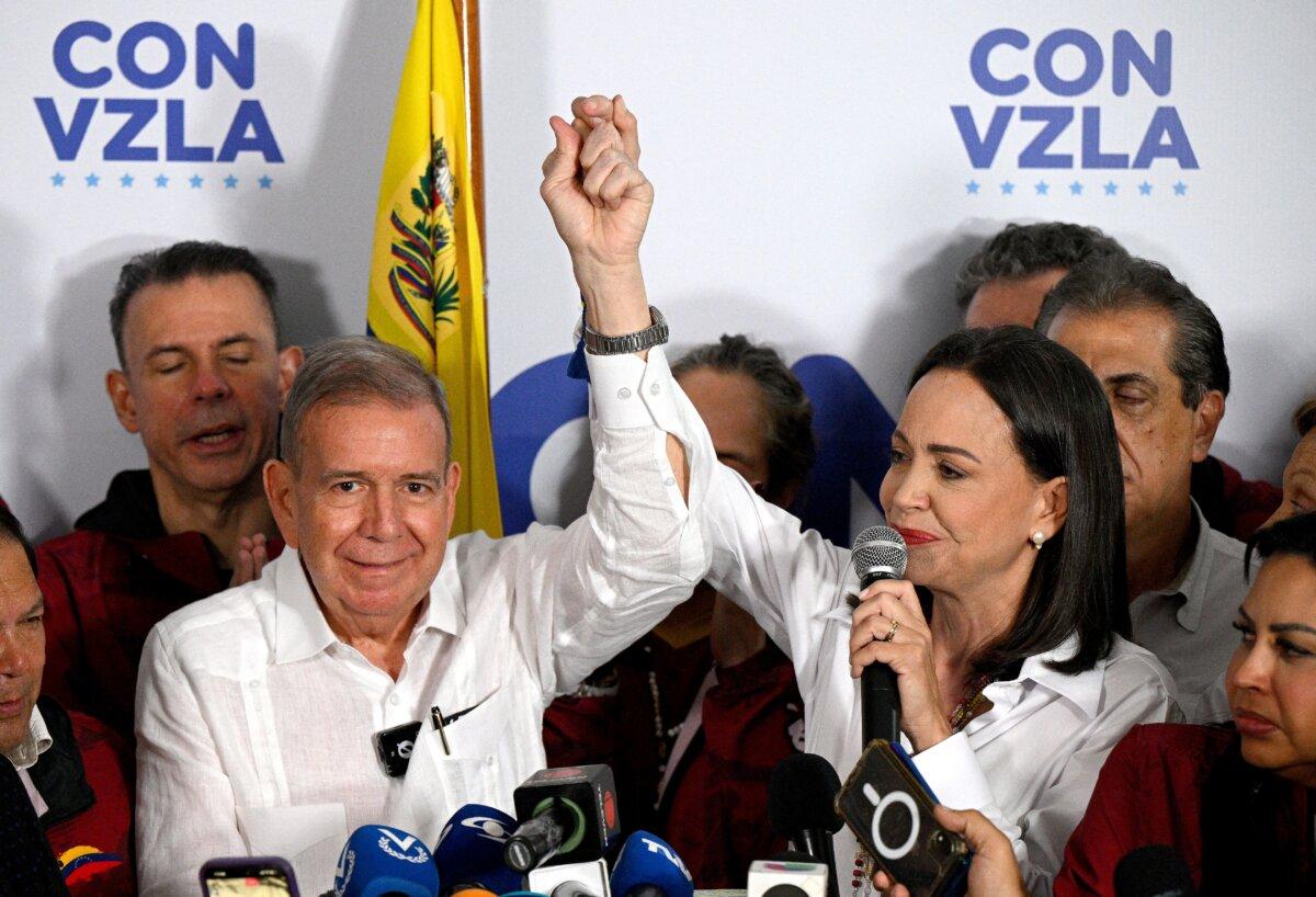 Venezuelan opposition leader Maria Corina Machado (R) talks to the media, accompanied by opposition presidential candidate Edmundo Gonzalez Urrutia (L), following the presidential election results in Caracas, on July 29, 2024. (Federico Parra/AFP via Getty Images)