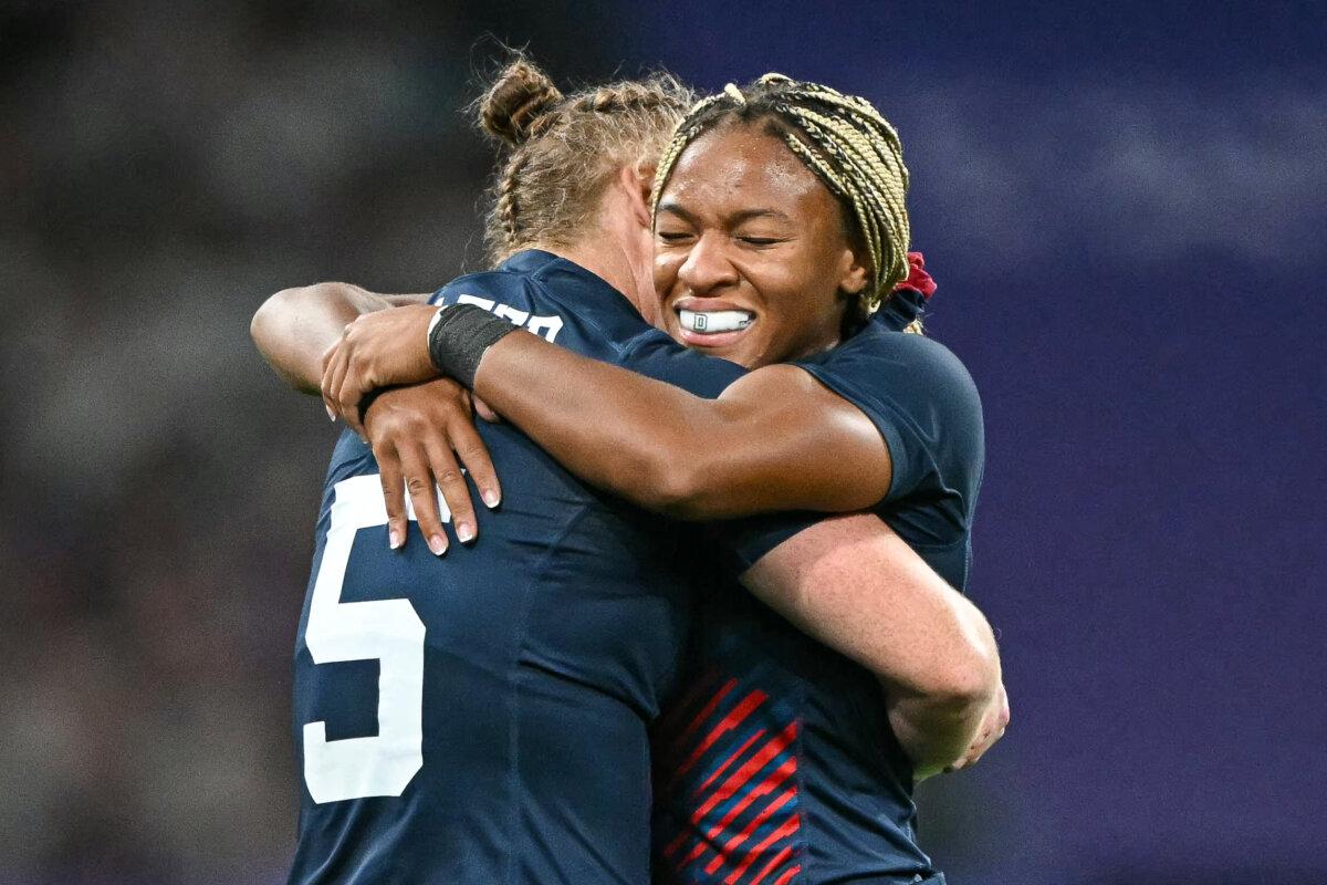 US' Ariana Ramsey (R) and US' Alev Kelter (L) celebrate after the women's quarter final rugby sevens match between Britain and USA during the Paris 2024 Olympic Games at the Stade de France in Saint-Denis on July 29, 2024. (Carl De Souza / AFP via Getty Images)