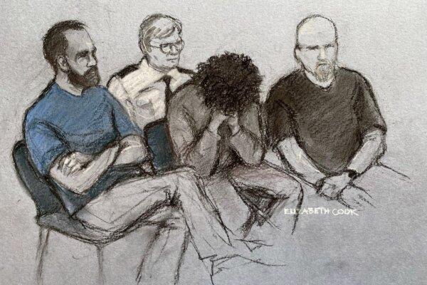 Court artist drawing of 17-year-old Axel Rudakubana (C) covering his face as he appeared in the dock at Liverpool Crown Court on Aug. 1, 2024. (Elizabeth Cook/PA Wire)