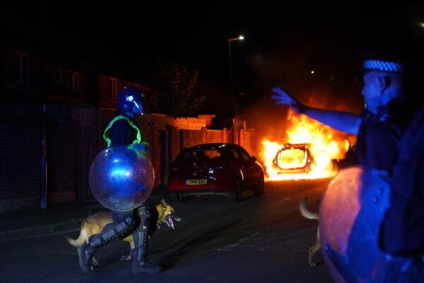 A police car burns as officers are deployed on the streets of Hartlepool following a violent protest on July 31, 2024. (Owen Humphreys/PA Wire)