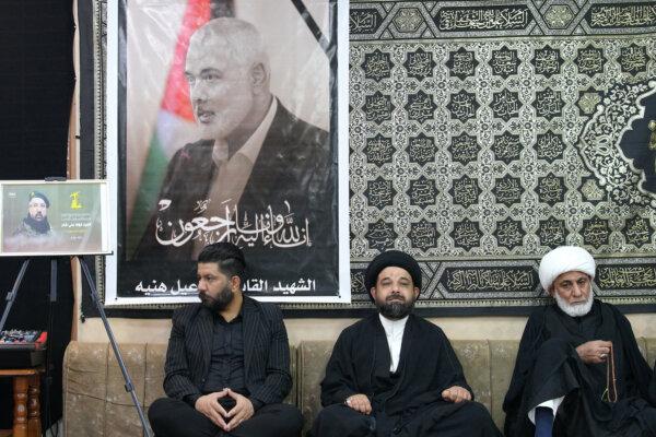 Iraqi and Iranian clerics and officials hold a vigil at the office of the representative of Iran's supreme leader in Iraq's Shiite holy city of Najaf following the death of Hamas leader Ismail Haniyeh (portrait) and others killed in strikes in Lebanon and Iraq, on Aug. 1, 2024. (Qassem Al-Kaabi/AFP via Getty Images)