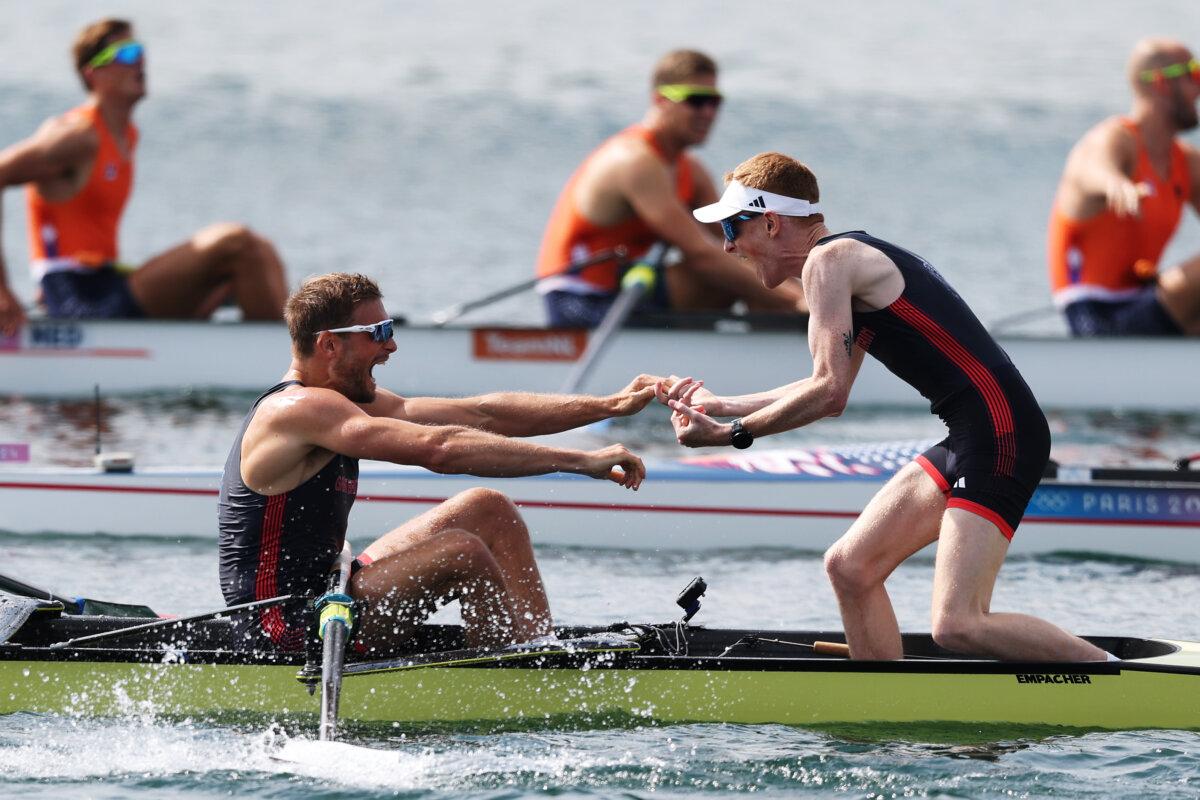 Cox Harry Brightmore celebrates as Tom Ford, James Rudkin, Tom Digby, Charles Elwes, Jacob Dawson, Morgan Bolding, Rory Gibbs, and Sholto Carnegie of Team Great Britain win gold in the Men's Eight Finals on day eight of the Olympic Games Paris 2024 at Vaires-Sur-Marne Nautical Stadium in Paris on August 3, 2024. (Francois Nel/Getty Images)