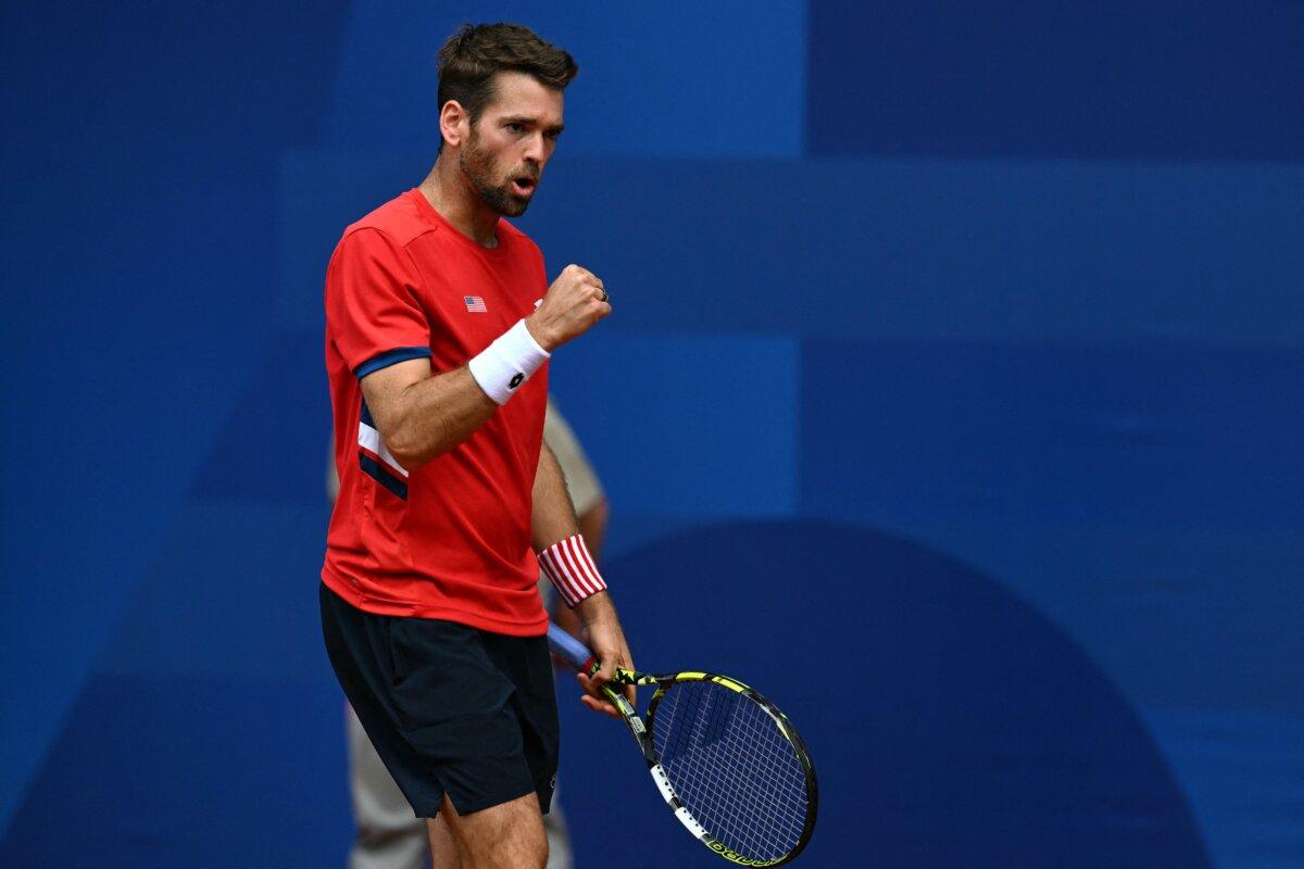 US' Austin Krajicek reacts while playing with US' Rajeev Ram against Australia's Matthew Ebden and Australia's John Peers during their men's doubles final tennis match on Court Philippe-Chatrier at the Roland-Garros Stadium during the Paris 2024 Olympic Games, in Paris on August 3, 2024. (Patricia De Melo Moreira/AFP via Getty Images)