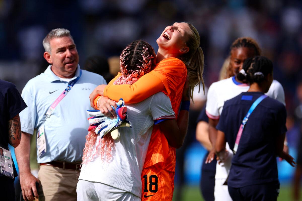 Casey Murphy #18 of Team United States celebrates victory with teammate Trinity Rodman #5 during the Women's Quarterfinal match between United States and Japan during the Olympic Games Paris 2024 at Parc des Princes in Paris on August 3, 2024. (Marc Atkins/Getty Images)