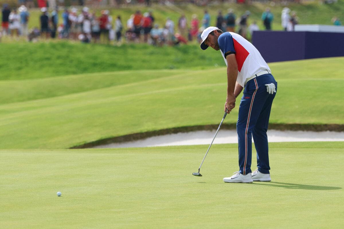 Scottie Scheffler of Team United States putts in round 4 of the men's golf individual stroke play of the Paris 2024 Olympic Games at Le Golf National in Guyancourt, southwest of Paris, on August 4, 2024. (Emmanuel Dunand/ AFP via Getty Images)