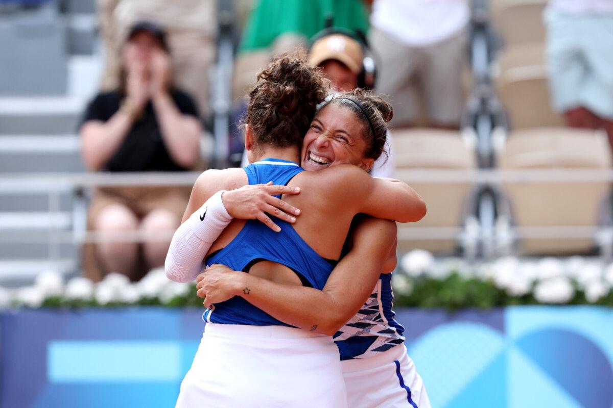 Sara Errani and Jasmine Paolini of Team Italy celebrate match point during the Women's Doubles Gold medal match against Mirra Andreeva and Diana Shnaider of Team Individual Neutral Athletes on day nine of the Olympic Games Paris 2024 at Roland Garros in Paris on August 4, 2024 (Clive Brunskill/Getty Images)