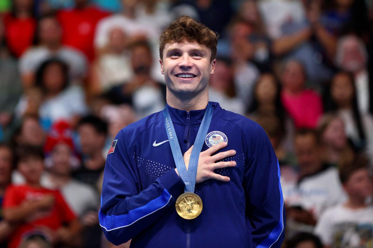 Gold Medalist Bobby Finke of Team United States stands on the podium during the Swimming medal ceremony after the Men's 1500m Freestyle Final on day nine of the Olympic Games Paris 2024 at Paris La Defense Arena in Nanterre, France, on August 4, 2024. (Maddie Meyer/Getty Images)