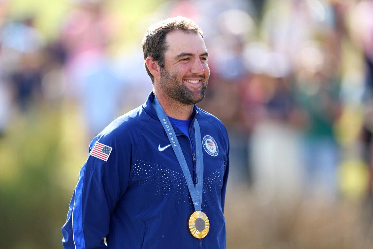 Gold medalist, Scottie Scheffler of Team United States poses on the podium during the Men's Individual Stroke Play medal ceremony following Day Four of the Men's Individual Stroke Play on day nine of the Olympic Games Paris 2024 at Le Golf National in Paris on August 4, 2024. (Andrew Redington/Getty Images)