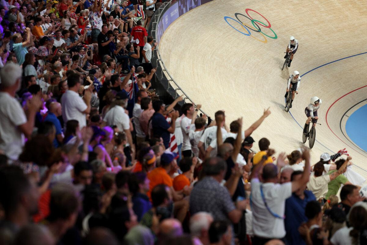 Gold medalists Chloe Dygert and Kristen Faulkner of Team United States celebrate after the Women's Team Pursuit Finals on day 12 of the Olympic Games at Saint-Quentin-en-Yvelines Velodrome in Paris on Aug. 7, 2024. (Alex Broadway/Getty Images)