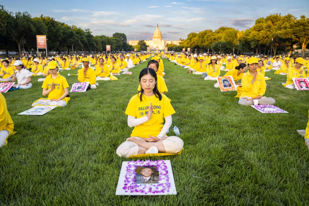 Falun Gong practitioners gather for a candlelight vigil commemorating Falun Gong practitionersí persecution to death in China by the Chinese Communist Party at the National Mall in Washington on July 11, 2024. (Madalina Vasiliu/The Epoch Times)
