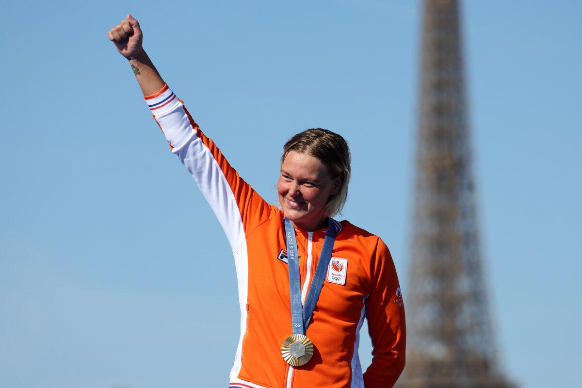 Gold Medalist Sharon van Rouwendaal of Team Netherlands celebrates on the podium after winning the marathon swimming women's 10k on day 13 of the Olympic Games at Pont Alexandre III in Paris on Aug. 8, 2024. (Clive Rose/Getty Images)
