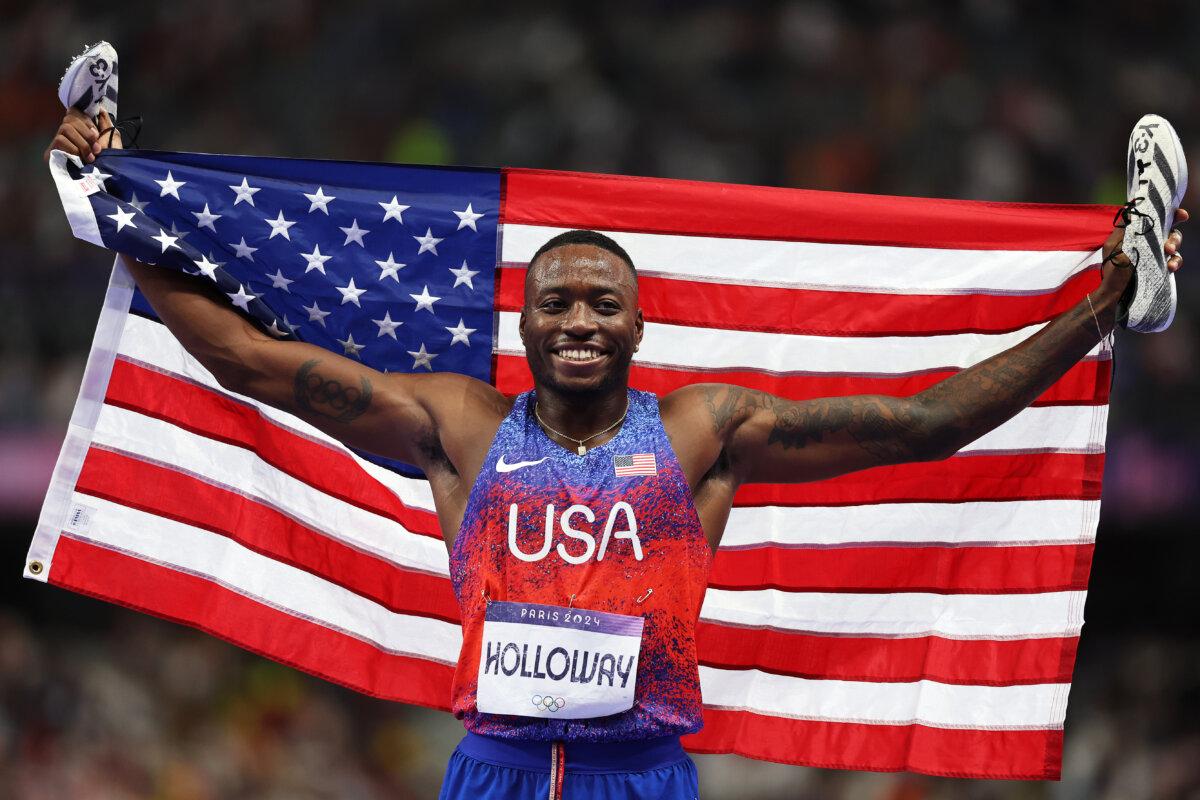 Grant Holloway of Team United States celebrates after winning the gold medal after competing in men's 110m hurdles on day 13 of the Olympic Games at Stade de France in Paris on Aug. 8, 2024. (Cameron Spencer/Getty Images)