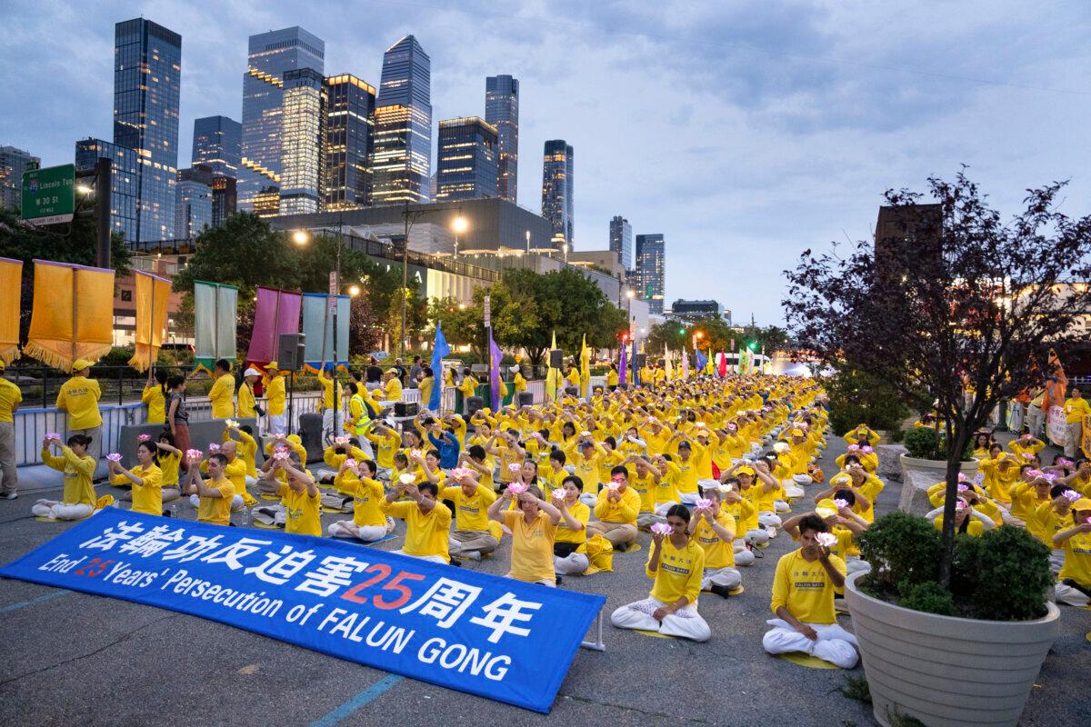 Falun Gong practitioners take part in a candlelight vigil in memory of Falun Gong practitioners who passed away during 25 years of ongoing persecution by the Chinese Communist Party, at the Chinese consulate in New York City, on July 20, 2024. (Larry Dye/The Epoch Times)