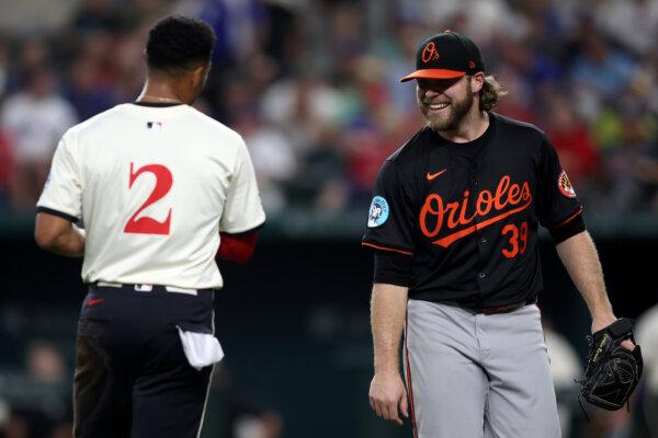 Corbin Burnes #39 of the Baltimore Orioles smiles at Marcus Semien #2 of the Texas Rangers after the third inning at Globe Life Field in Arlington, Texas, on July 19, 2024. (Tim Heitman/Getty Images)