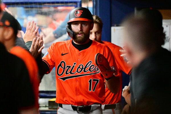 Colton Cowser, #17 of the Baltimore Orioles, celebrates with teammates in the dugout after scoring in the first inning against the Tampa Bay Rays at Tropicana Field in St. Petersburg, Florida, on Aug. 10, 2024. (Julio Aguilar/Getty Images)
