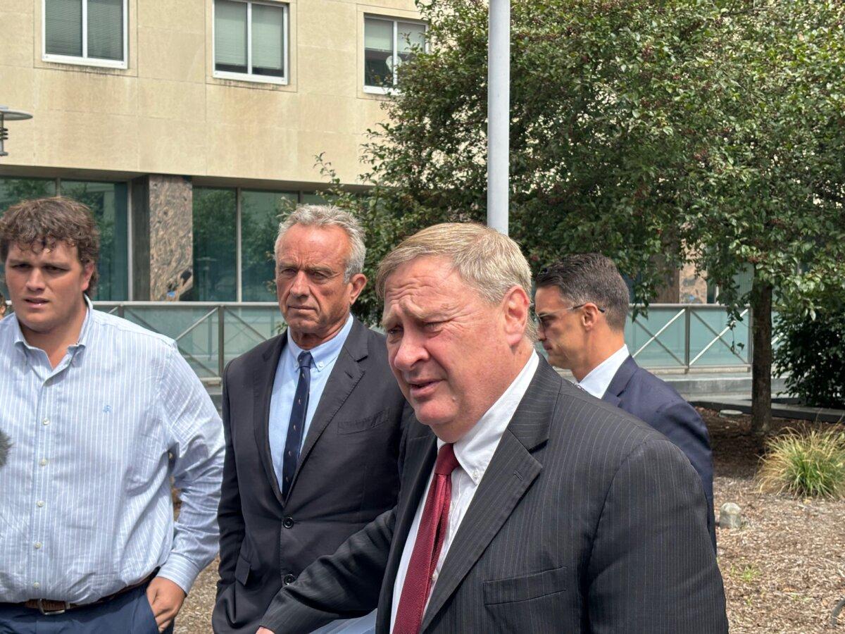 Attorney Paul Rossie (R) and independent presidential candidate Robert F. Kennedy Jr. (2nd L) talk to reporters in Harrisburg, Pa., on Aug. 20 after a ballot access hearing. (Jeff Louderback/The Epoch Times)