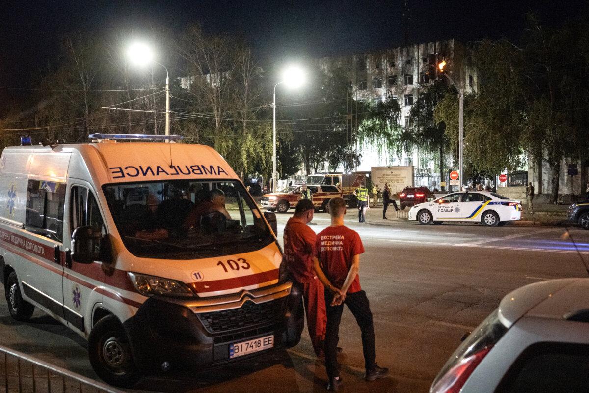 Medical workers wait outside a military educational facility after it was hit by Russian missiles in Poltava, eastern Ukraine, on Sept. 3, 2024 (Patryk Jaraccz/AFP via Getty Images)
