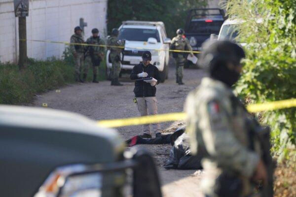 Forensic investigators work at the site of a body lying in the street in Culiacan, Sinaloa state, Mexico, on Sept. 19, 2024. (Eduardo Verdugo/AP)