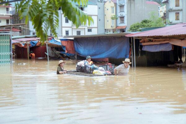 People carry belongings in a flood triggered by Typhoon Yagi in Lang Son Province, Vietnam, on Sept. 9, 2024. (Nguyen Anh Tuan/VNA via AP)
