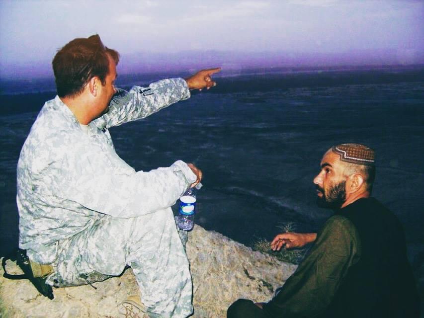 Mann meeting with an Afghani village local. (Courtesy of Scott Mann)