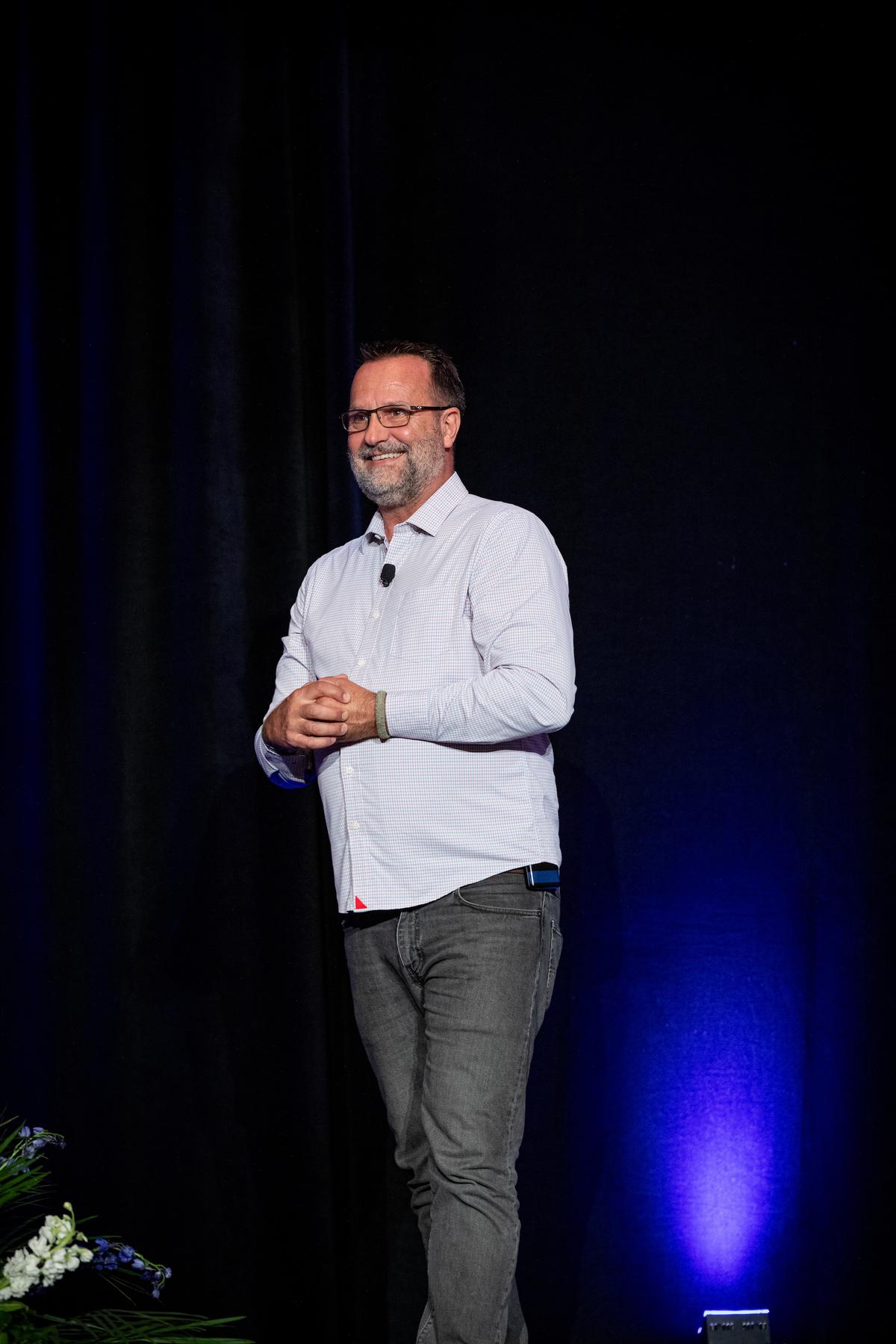 Mann giving a speech on leadership at a company event in 2023. (Courtesy of Scott Mann)
