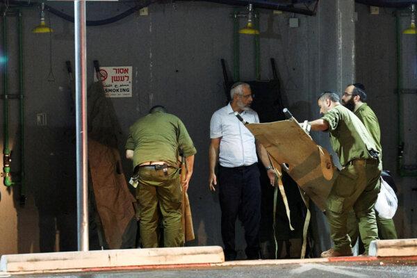 After assisting with the casualties from a Hezbollah drone attack, Israeli soldiers fold gurneys at Sheba Medical Center in Ramat Gan, Israel, on Oct. 13, 2024. (Violeta Santos Moura/Reuters)