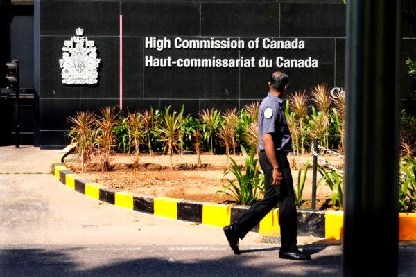 A private security guard walks outside the Canadian high commission in New Delhi, India, on Oct. 15, 2024. (AP Photo/Manish Swarup)