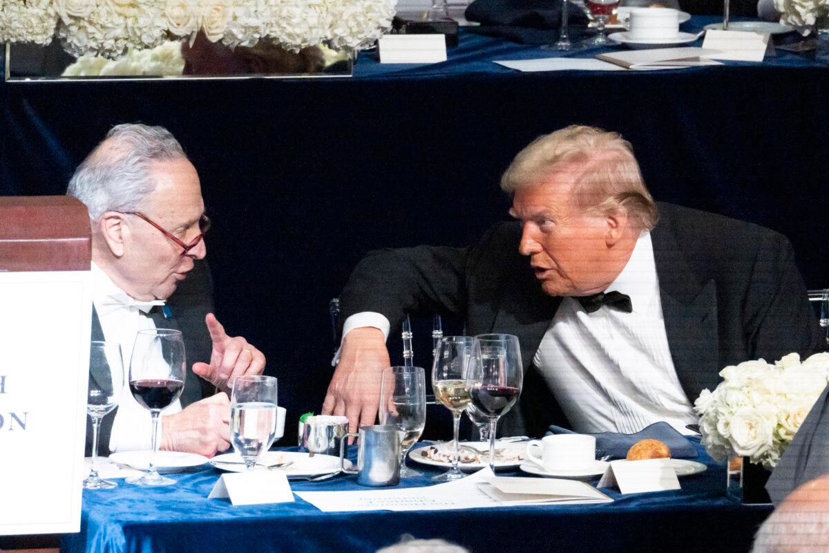 Former President Donald Trump (R) and Sen. Chuck Schumer (L) chat at the 79th annual Alfred E. Smith Memorial Foundation Dinner at the New York Hilton Midtown in New York City on Oct. 17, 2024. (Samira Bouaou/The Epoch Times)